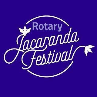 White Rotary Jacaranda Festival logo on a solid purple background.